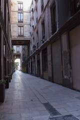 a narrow street between houses in the old quarter of the city