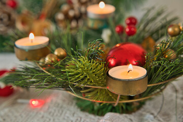 candles lighting in christmas wreath on table with christams light and decorations, Mahe Seychelles