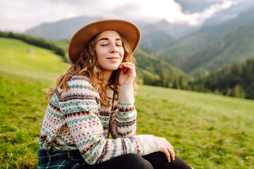 Outdoor portrait of happy tourist admiring the landscape mountains nature. Travel, nature concept.