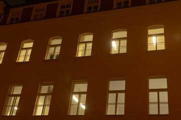 Europe building adorned with numerous windows that illuminate beautifully during the nighttime...