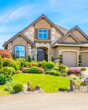 Two story stucco luxury house with nice summer  landscape in Vancouver, Canada, North America. Day time on June 2024.