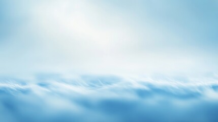 Fototapeta premium Aerial view of soft blurry white clouds under a clear blue sky ideal for nature and travel presentation backgrounds.