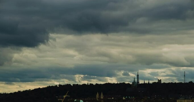 Stratocumulus Blanket Over Petř&iacute;n Silhouetted Horizon with the Tower Emerging Beneath Patches of Light and Shade Moving Across an Overcast Sky in Moody 4K Time Lapse