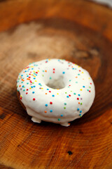 A selection of freshly baked donuts in multi-colored glaze. Beautiful sweet donuts with sprinkles. Dessert close-up. 