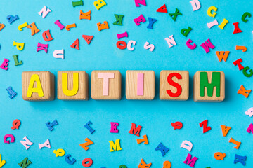 Autism awareness day.2 April world autism awareness day background.Design element.Care Awareness campaign for Autism.AUTISM text with colorful wooden puzzles, letters and cubes.Space for text.Top view