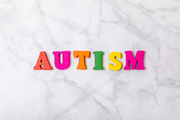 Autism awareness day.2 April world autism awareness day background.Design element.Care Awareness campaign for Autism.AUTISM text with colorful wooden puzzles, letters and cubes.Space for text.Top view