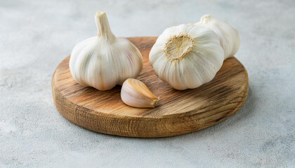Fresh garlic on wooden board. Cooking and culinary concept. Stone background.