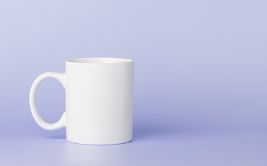 white cup for tea or coffee on a violet, purple background