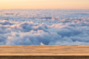 The blur cool cloud background with wood floor foreground on horizon tropical sandy beach relaxing outdoors vacation with heavenly mind view at a resort deck touching sunshine, sky surf summer clouds.