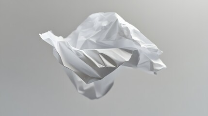 A crumpled piece of white paper floating mid-air over a gray backdrop.