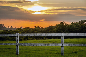 Fototapeta premium sunset over the fence