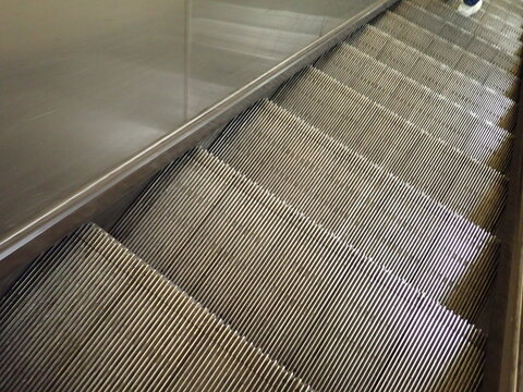 moving steps of escalator in metro
