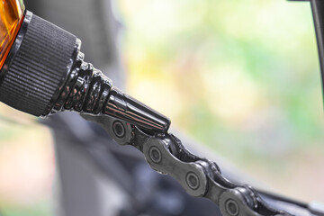 close up of male hand putting oil on bike chain, lubricating bike chain, greasing a bicycle chain, bicycle maintenance