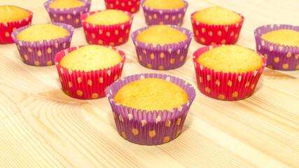colorful cupcakes on wooden table background