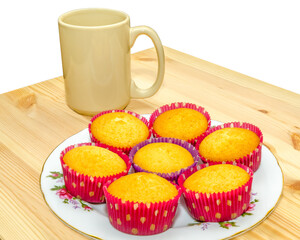 colorful cupcakes on wooden table background