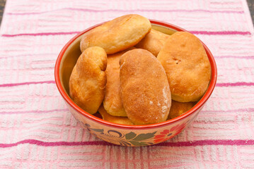 Basket full of pirogies over pink background.