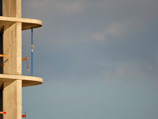 Unfinished building under construction, with a focus on the concrete framework and rebar Part of a...