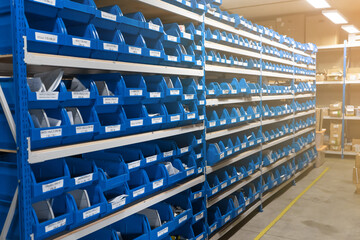 A wellorganized warehouse featuring blue storage bins for improved efficiency and accessibility