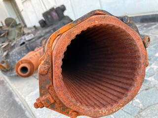 Close-up image of a corroded large caliber gun or cannon with rifling design Background shows an...