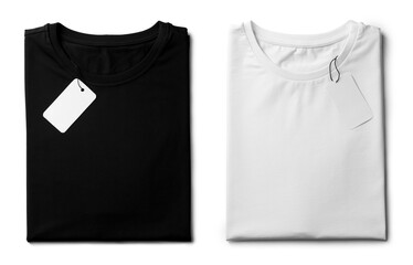 White and black folded t-shirts with labels isolated on white, top view. Mockup for design