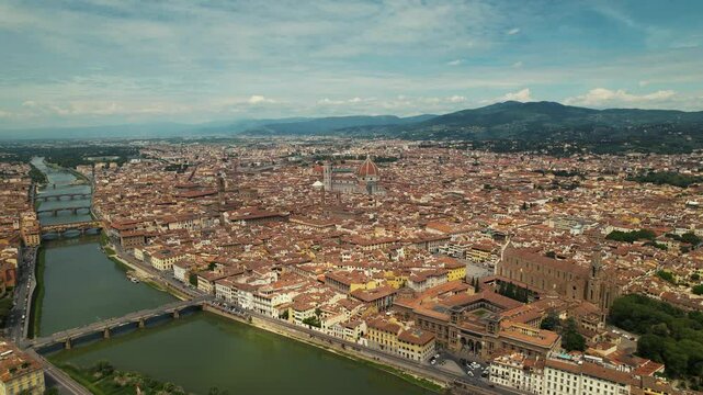 Aerial drone view over the Arno River in Florence Italy on a cloudy day. Tuscany, Italy