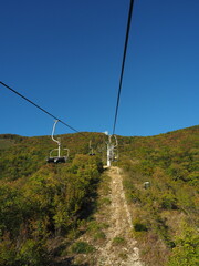 Cable car in the mountains on a background of blue sky.