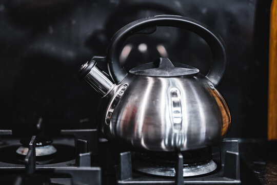 The kettle is on the gas stove.