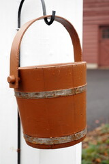 The water bucket is next to the old water pump.