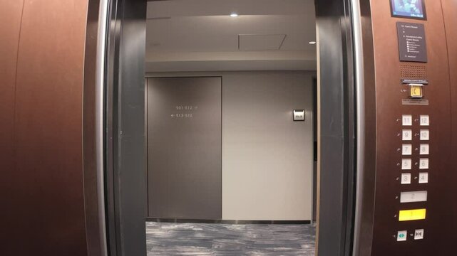 A contemporary modern elevator interior featuring open doors leading to convenient lobby access