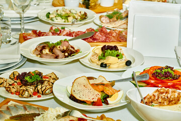 Festive delicious appetizers,snacks and salads on the banquet wedding table