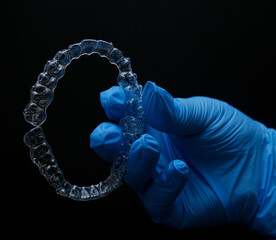 Treatment with clear aligners by a dental orthodontic specialist. Alignment of misaligned teeth known as aligner therapy. © UniqDream