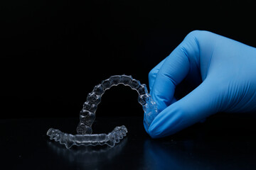 Treatment with clear aligners by a dental orthodontic specialist. Alignment of misaligned teeth known as aligner therapy. © UniqDream