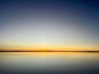 Obraz premium Sunrise Reflection on Water Covered Salt Flats in Uyuni, Bolivia