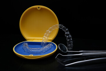 Treatment with clear aligners by a dental orthodontic specialist. Alignment of misaligned teeth known as aligner therapy. © UniqDream