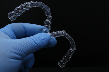 Treatment with clear aligners by a dental orthodontic specialist. Alignment of misaligned teeth known as aligner therapy. © UniqDream