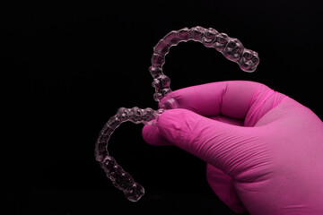 Treatment with clear aligners by a dental orthodontic specialist. Alignment of misaligned teeth known as aligner therapy. © UniqDream