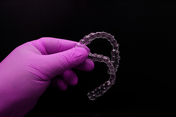 Treatment with clear aligners by a dental orthodontic specialist. Alignment of misaligned teeth known as aligner therapy. © UniqDream