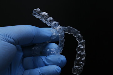 Treatment with clear aligners by a dental orthodontic specialist. Alignment of misaligned teeth known as aligner therapy. © UniqDream