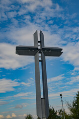 metal cross against the blue sky at the viewpoint in Żywiec