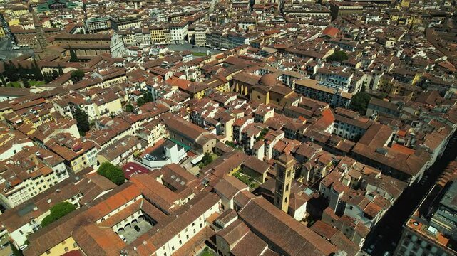 Florence seen from above, reveals a tapestry of picturesque architecture, weaving history and beauty under the blue sky