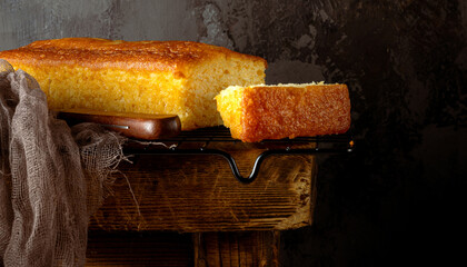 Vanilla cupcake on a metal plate placed on an old wooden bench. The rustic setting highlights the...