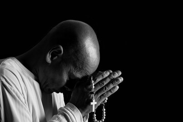 man praying to god with hands together worshiping God Caribbean man praying with people stock image stock photo