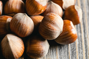 Hazelnuts on a wooden surface, organic natural food, nuts macro, food background.