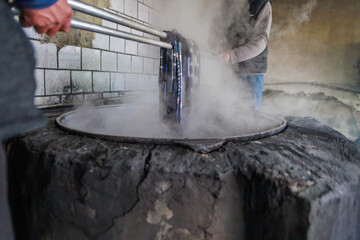 The process of silk dyeing in pan on stove.