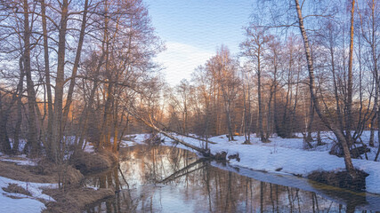 Snowy landscape with a river and trees