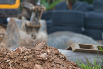 Naklejka premium A pile of dirt with a large piece of equipment in the background