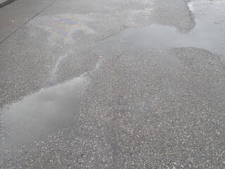 Obraz premium asphalt road with broken cracks after rain