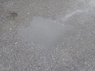 asphalt road with broken cracks after rain