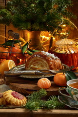 Croissant with tea and tangerines on a wooden background