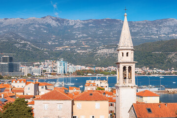 Budva old town skyline with terracotta roofs, bell tower and adriatic sea in Montenegro